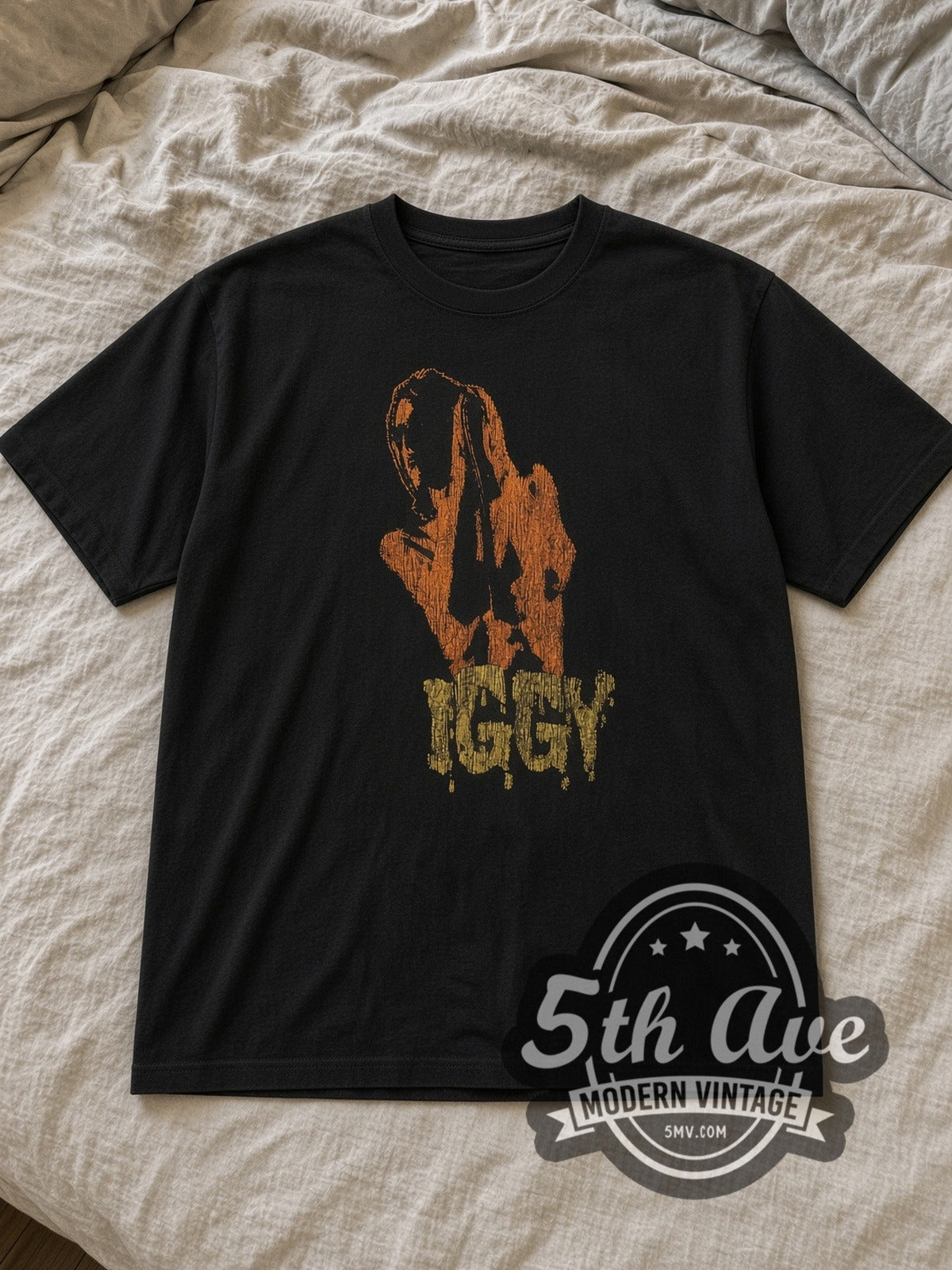 Black Iggy and The Stooges Raw Power 1973 Vintage Band T-Shirt laid flat on a linen bed