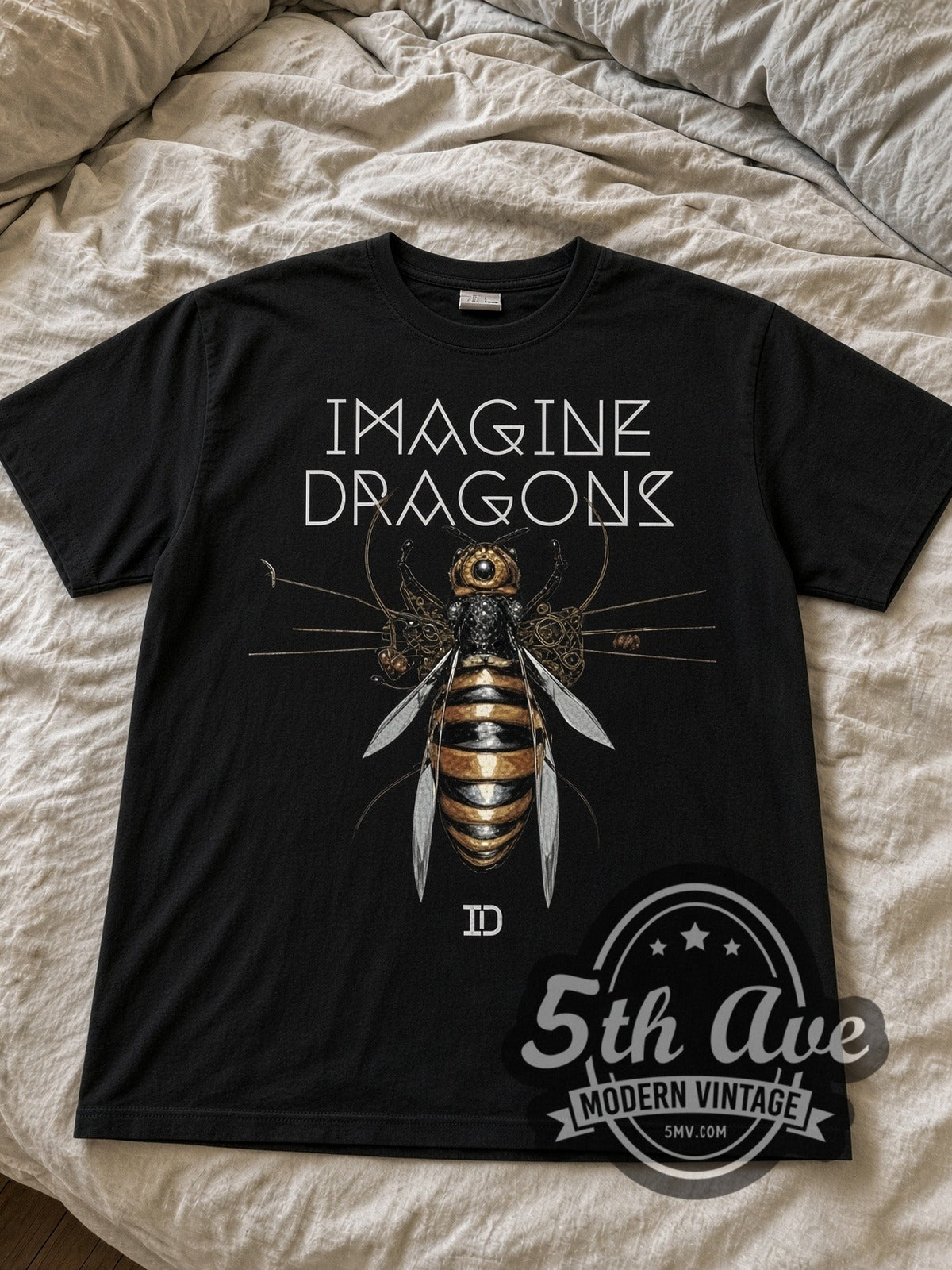 Imagine Dragons Mechanical Bee black graphic tee laid flat on linen bed