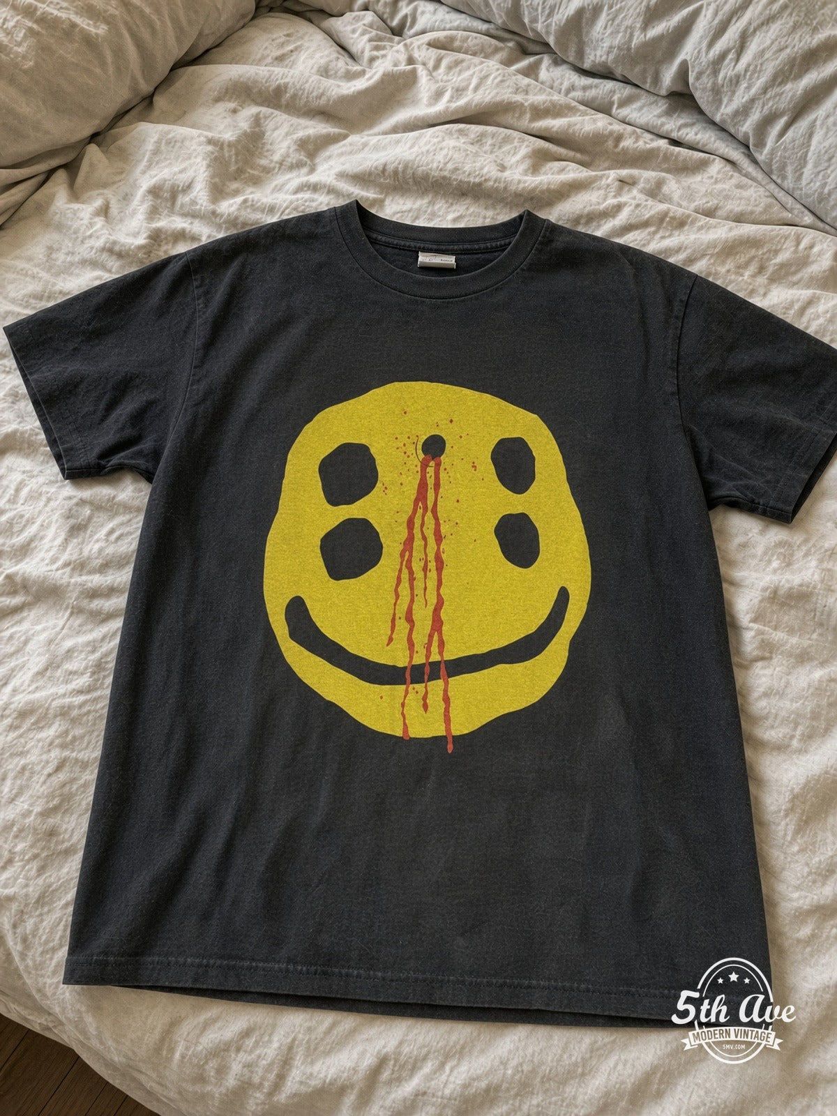 Immaculate Possession Chaotic Beasts Bleeding Smiley vintage tee laid on bed