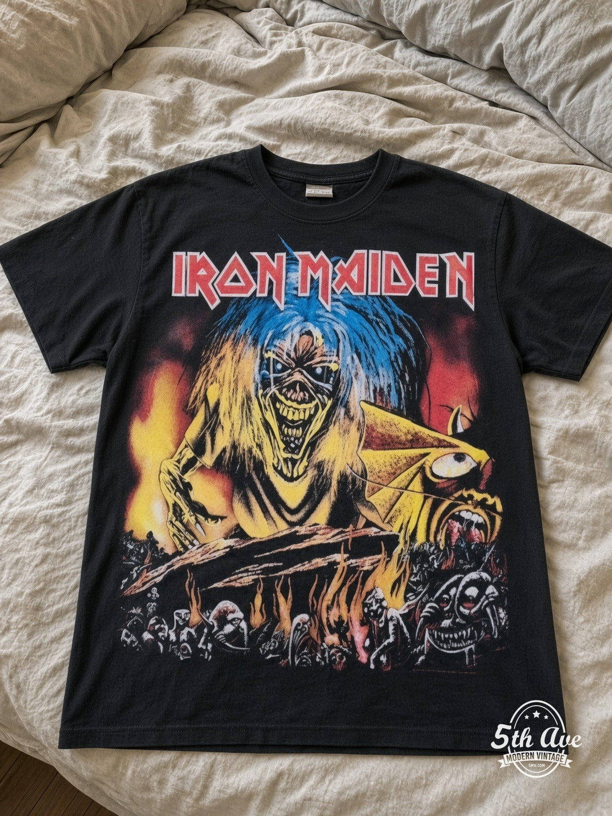 Iron Maiden Eddie Fire Hellscape all over print vintage tee laid on bed