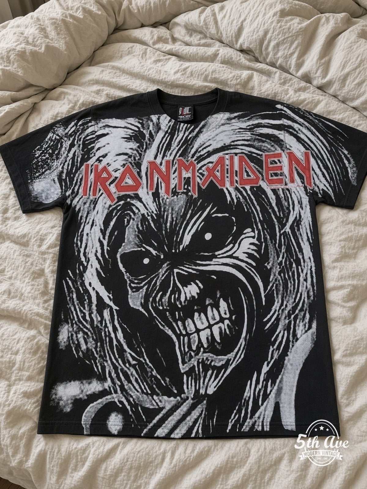 Iron Maiden Eddie Snarl Bloody Hand Black all over print vintage tee laid on bed