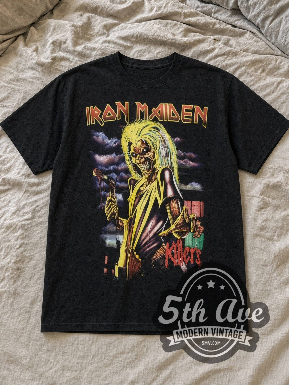 Black Iron Maiden Killers Album Art City Skyline Vintage Band T-Shirt laid flat on a linen bed