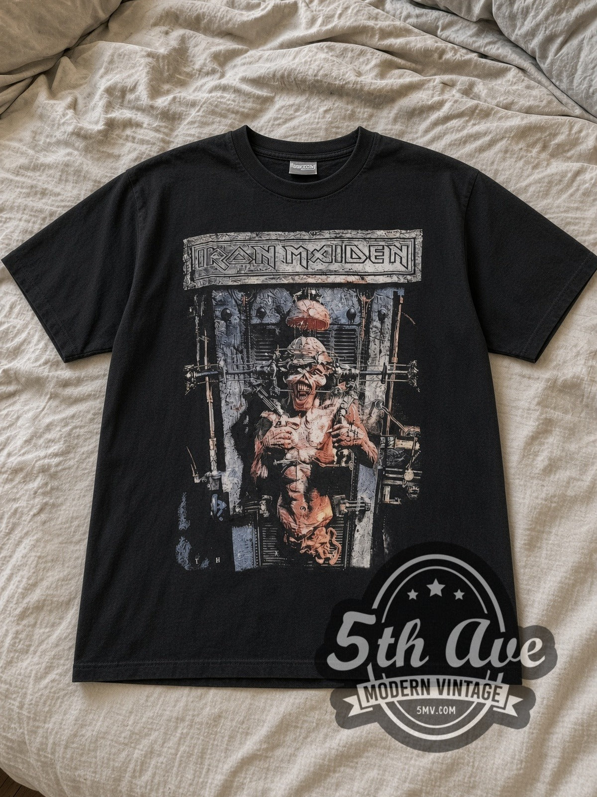 Black Iron Maiden The X Factor Tour 1995 Vintage Band T-Shirt laid flat on a linen bed