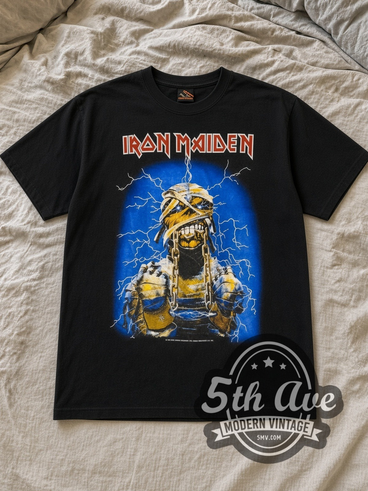 Black Iron Maiden World Slavery Tour 1984/85 Vintage Band T-Shirt laid flat on a linen bed