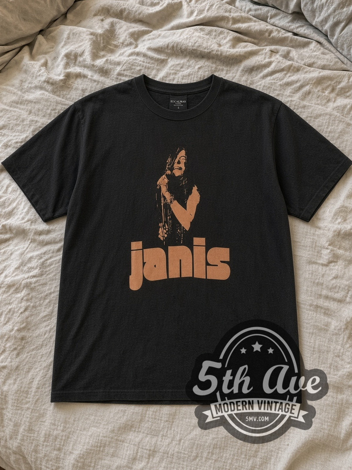 Black Janis Joplin Vintage Band T-Shirt laid flat on a linen bed