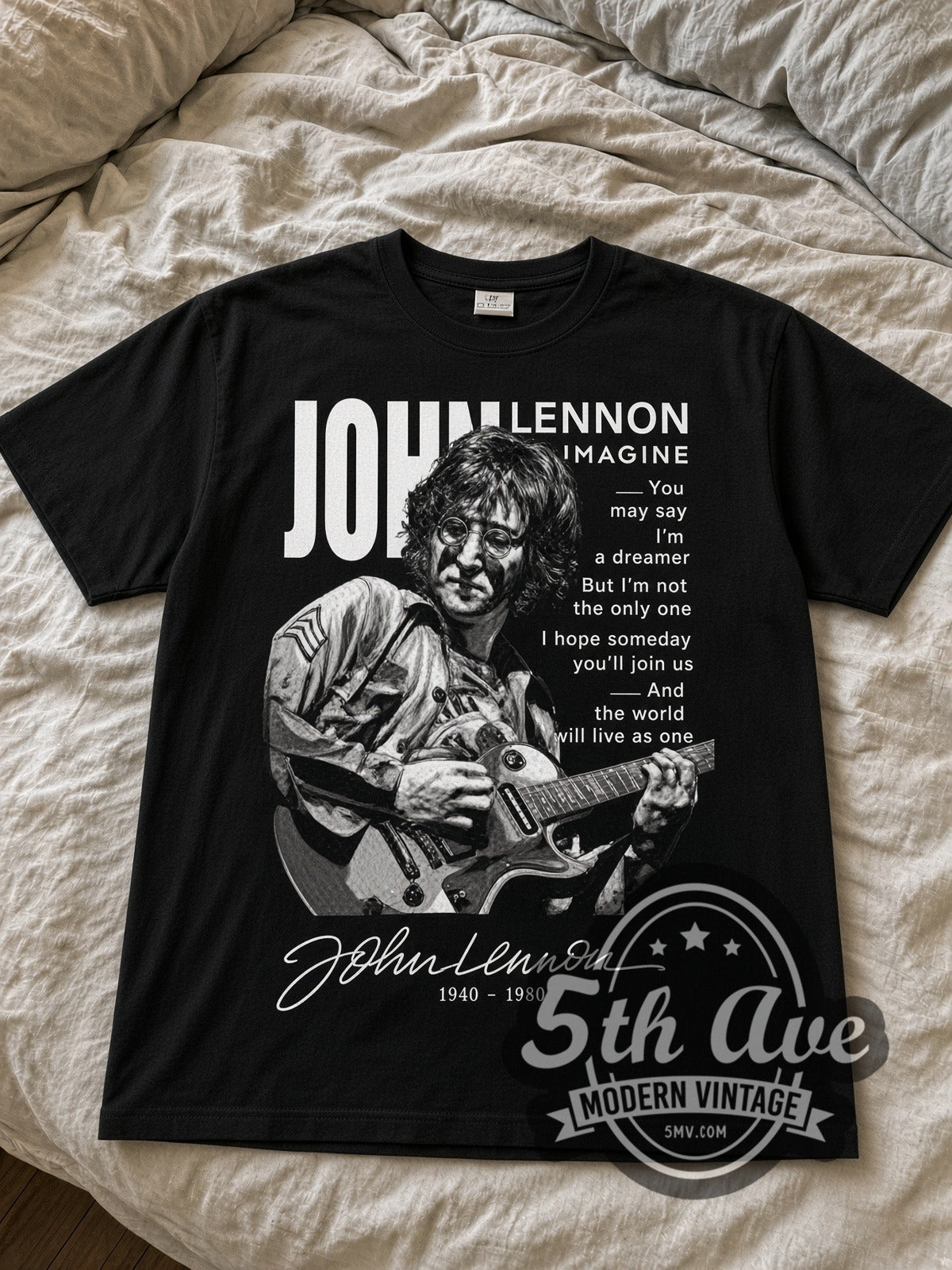 John Lennon Imagine Lyrics Portrait black graphic tee laid flat on linen bed