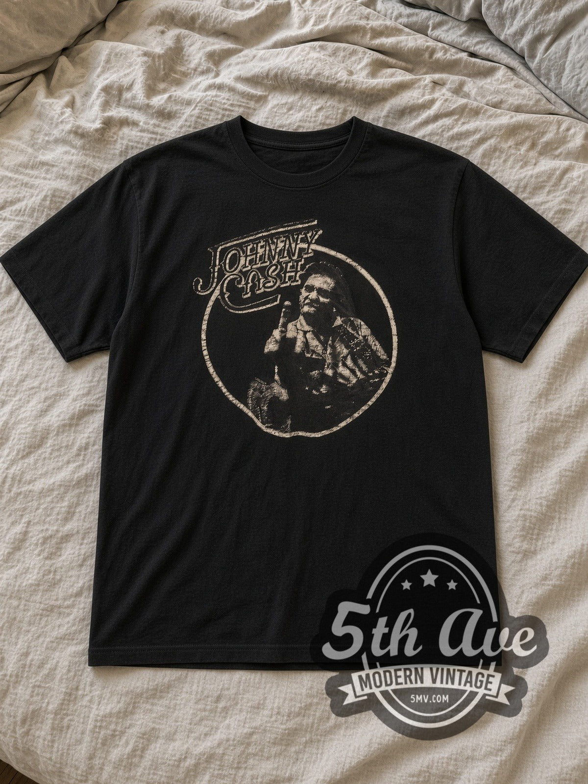 Black Johnny Cash Circle Portrait Vintage Band T-Shirt laid flat on a linen bed
