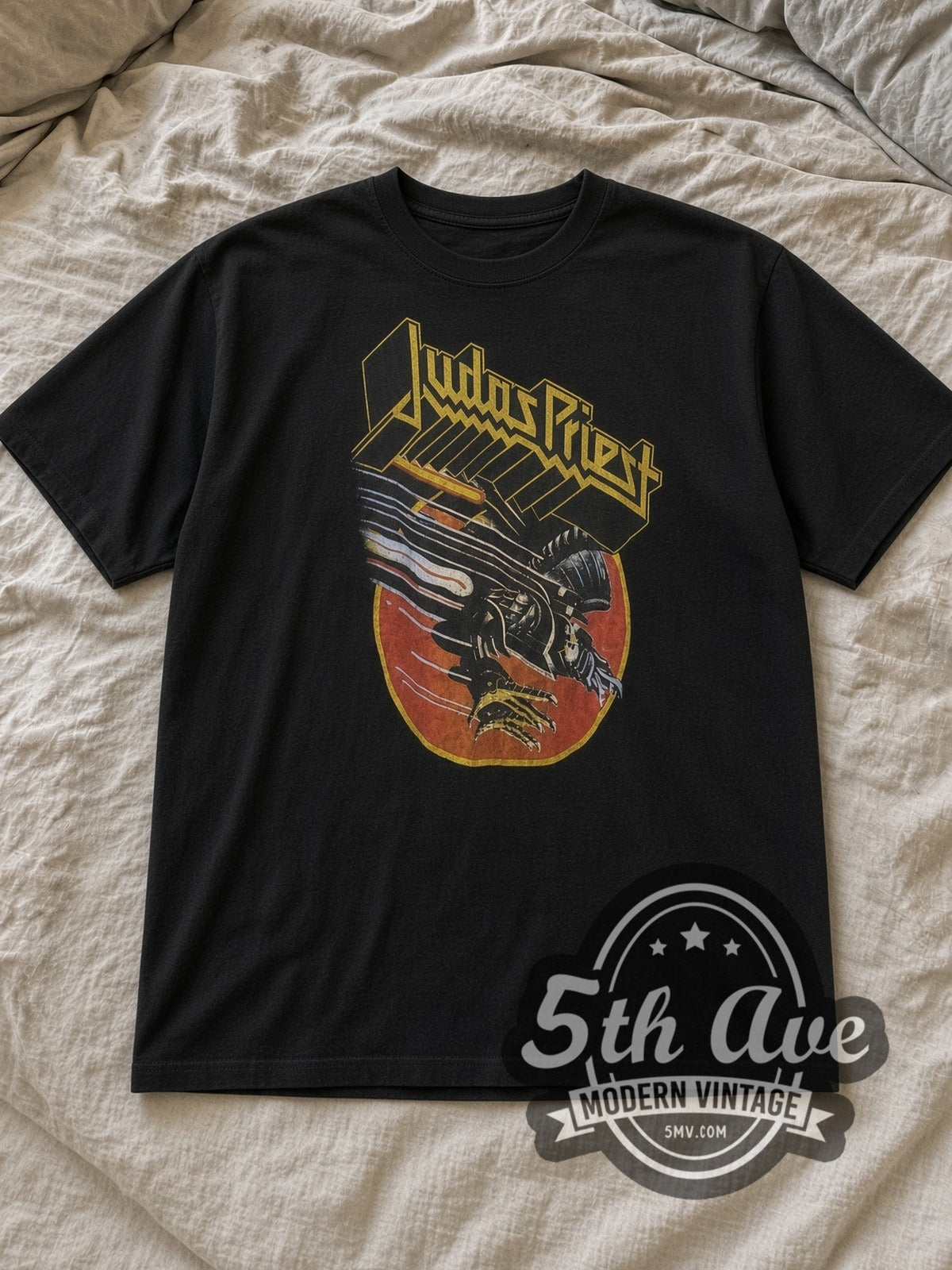 Black Judas Priest Robotic Eagle Vintage Band T-Shirt laid flat on a linen bed