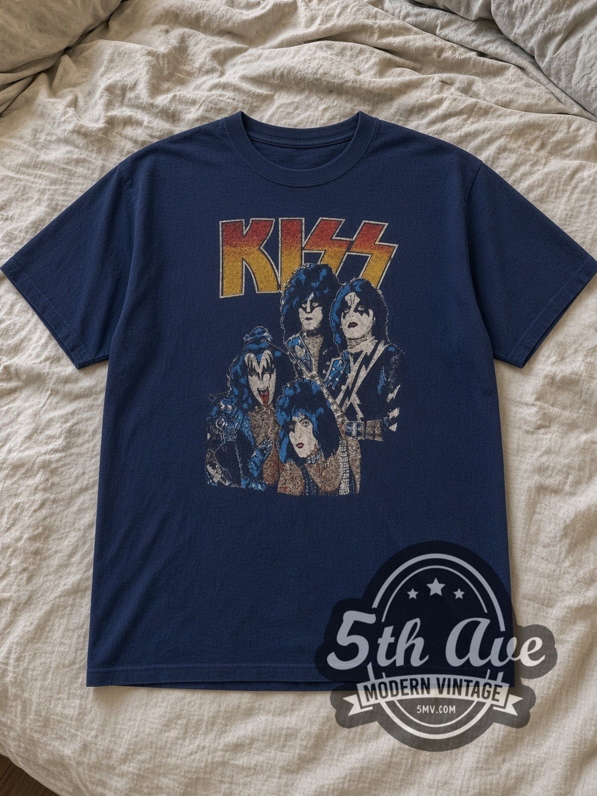Navy KISS Triple Logo Vintage Band T-Shirt laid flat on a linen bed