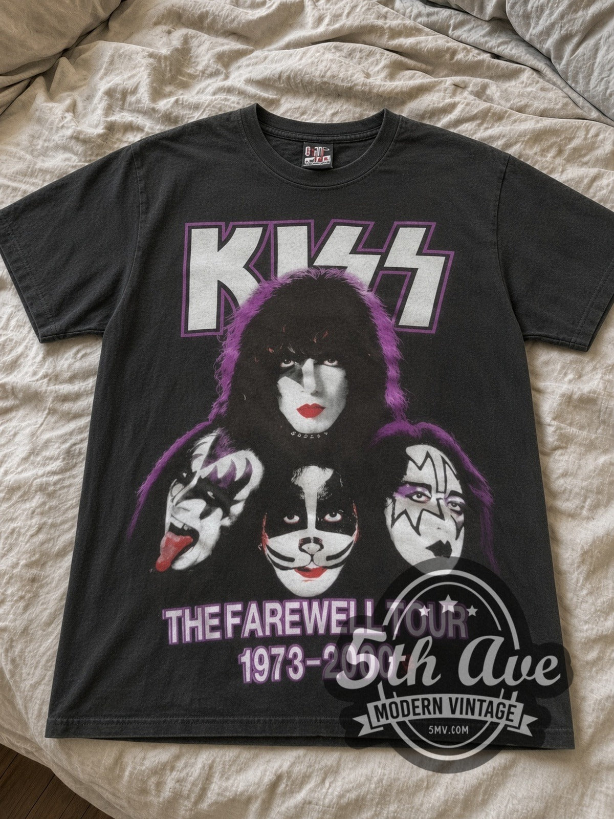 KISS Legends Never Die Farewell Tour band t-shirt in black laid flat on a bed, front artwork