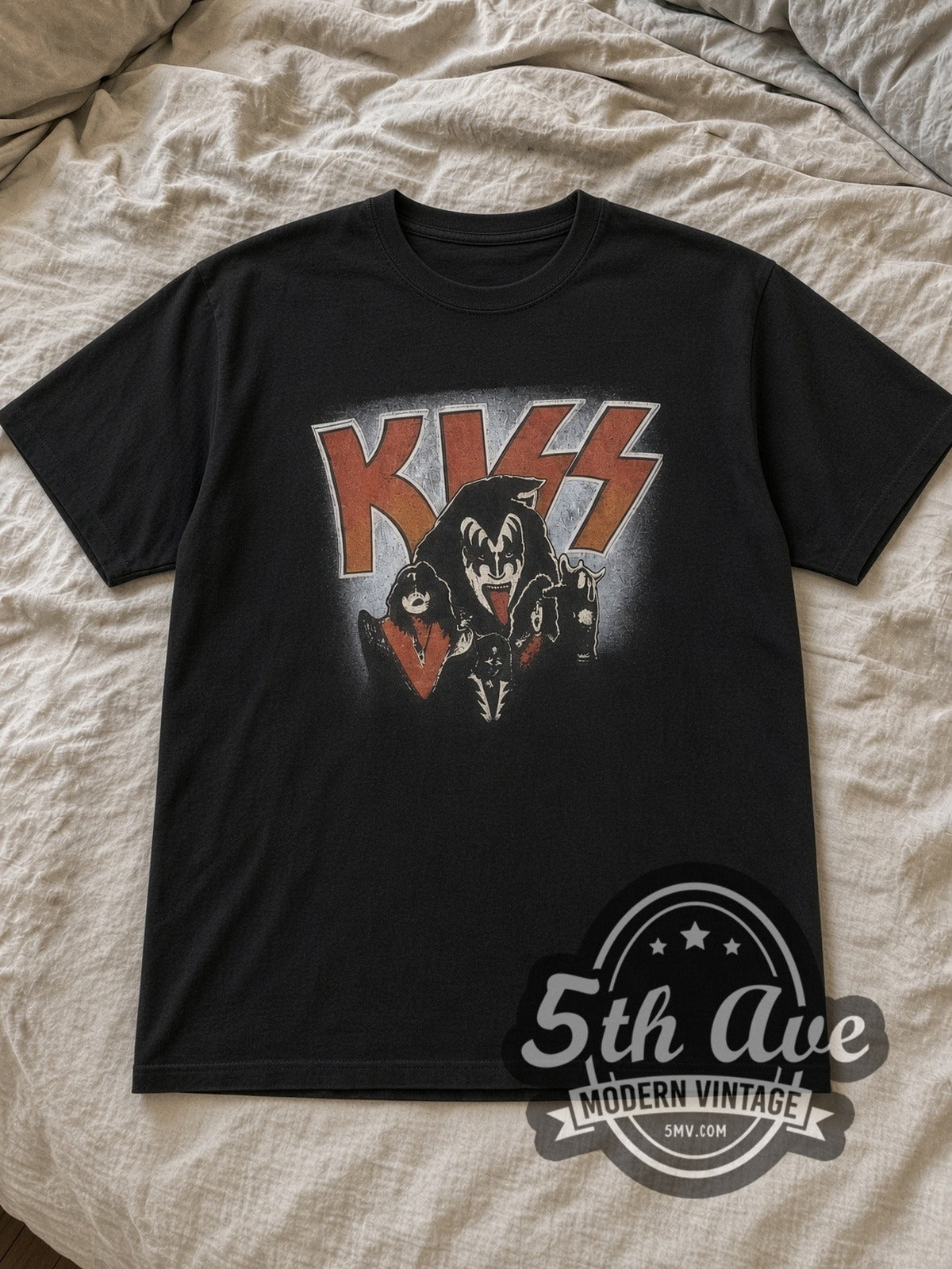 Black KISS Demon Logo Vintage Band T-Shirt laid flat on a linen bed
