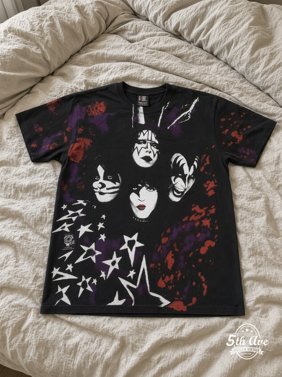 KISS Starfield Faces all over print vintage tee laid on bed