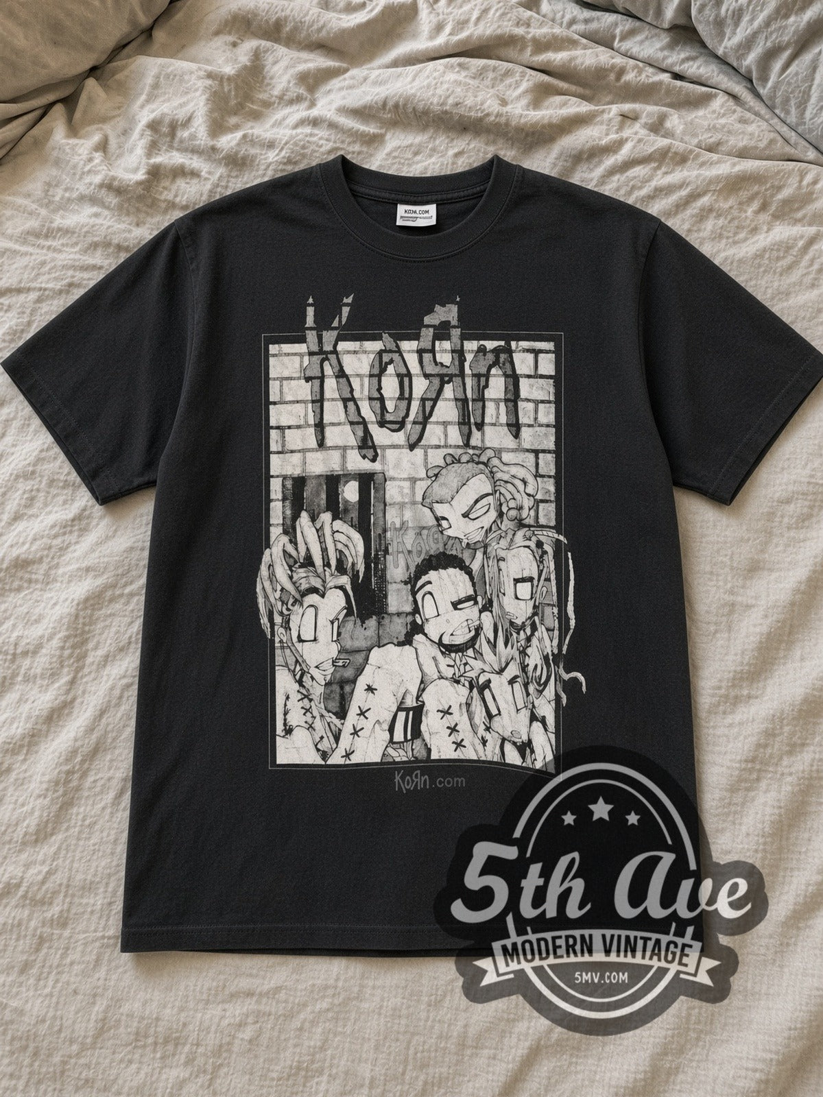 Black Korn Sick and Twisted Tour 2000 (Monochrome) Vintage Band T-Shirt laid flat on a linen bed