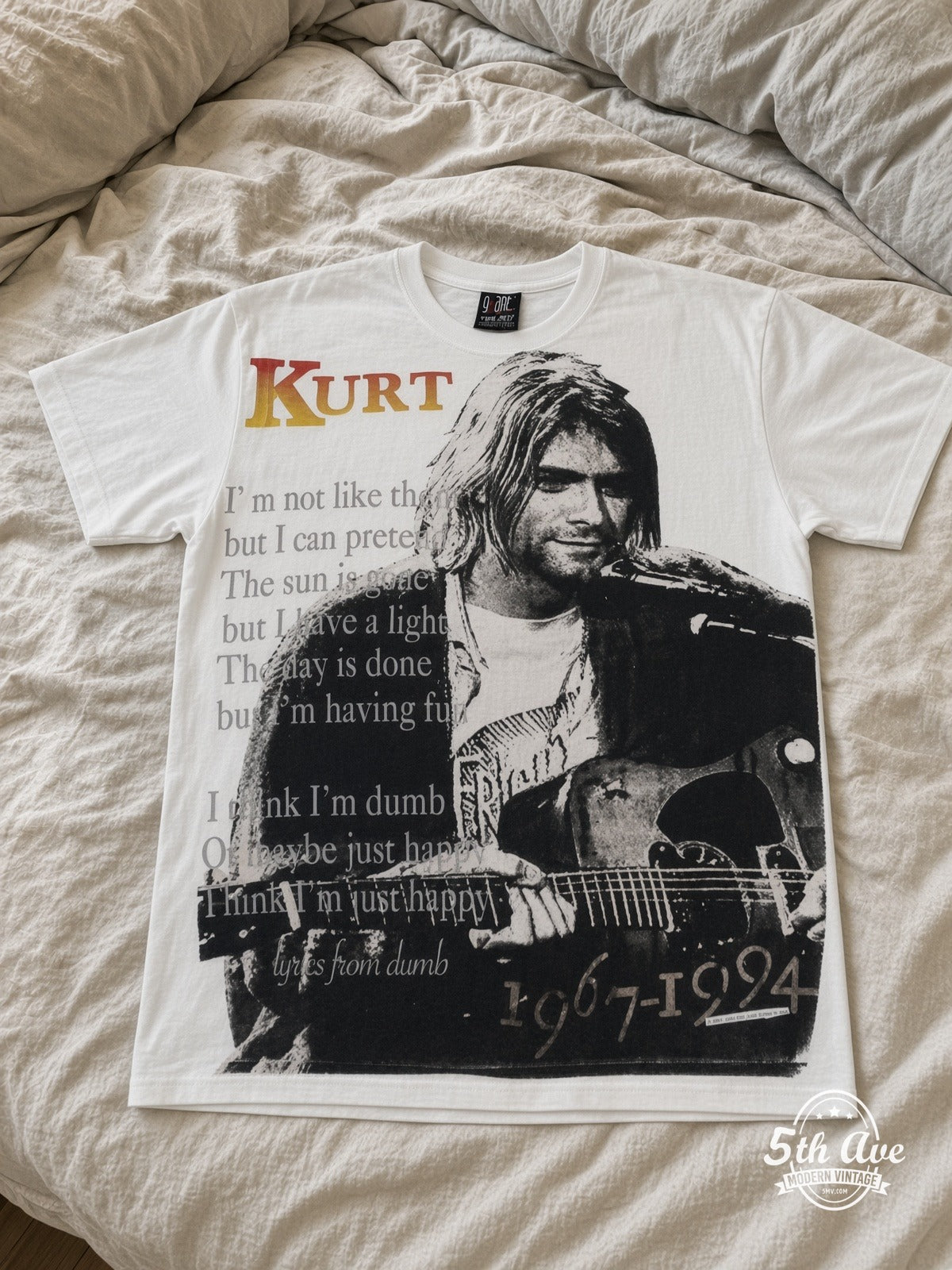 Kurt Cobain 1967-1994 Live At Last all over print vintage tee laid on bed