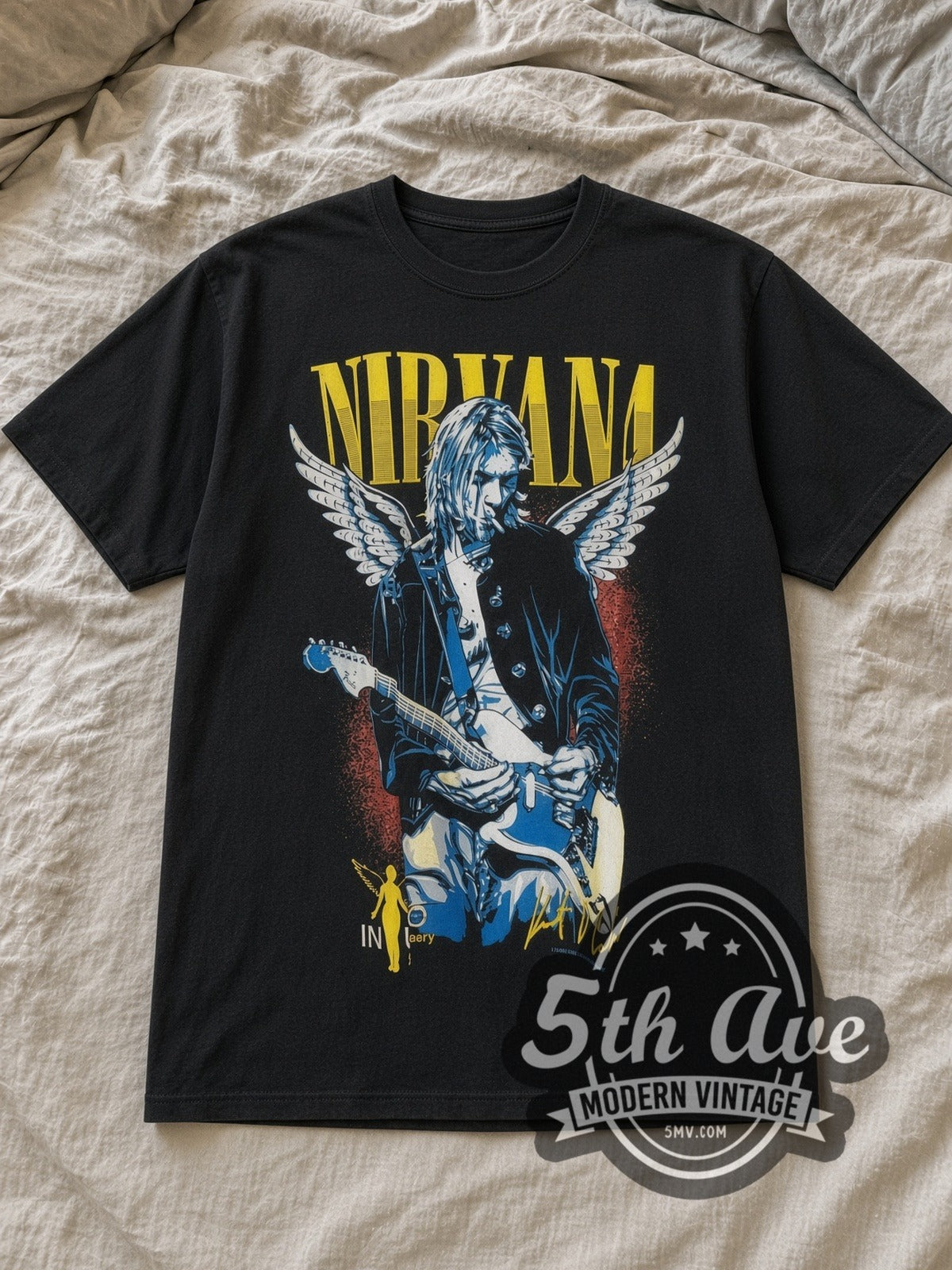 Black Kurt Cobain / Nirvana Vintage Band T-Shirt laid flat on a linen bed