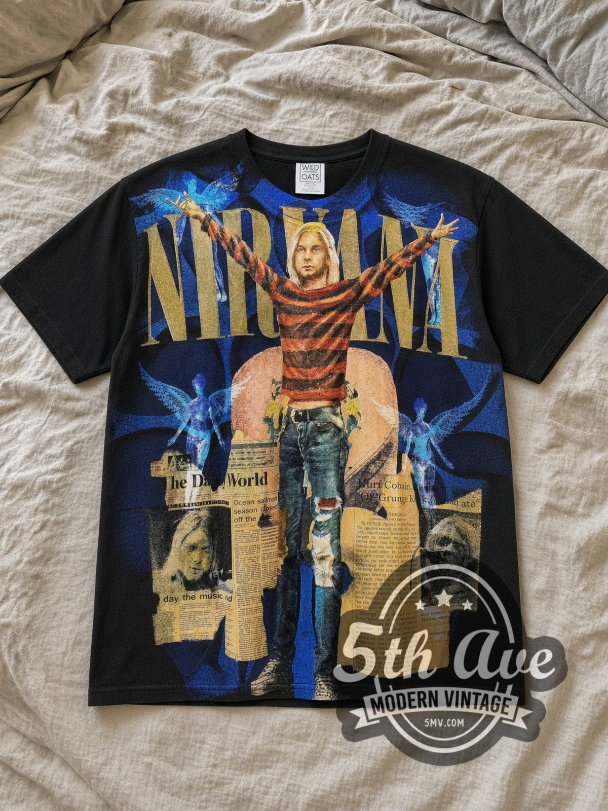 Black Kurt Cobain Nirvana in The Daily World All Over Print Vintage Band T-Shirt laid flat on a linen bed