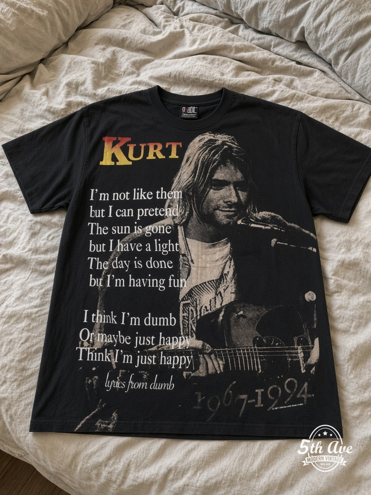 Kurt Cobain Nirvana Live At Last all over print vintage tee laid on bed