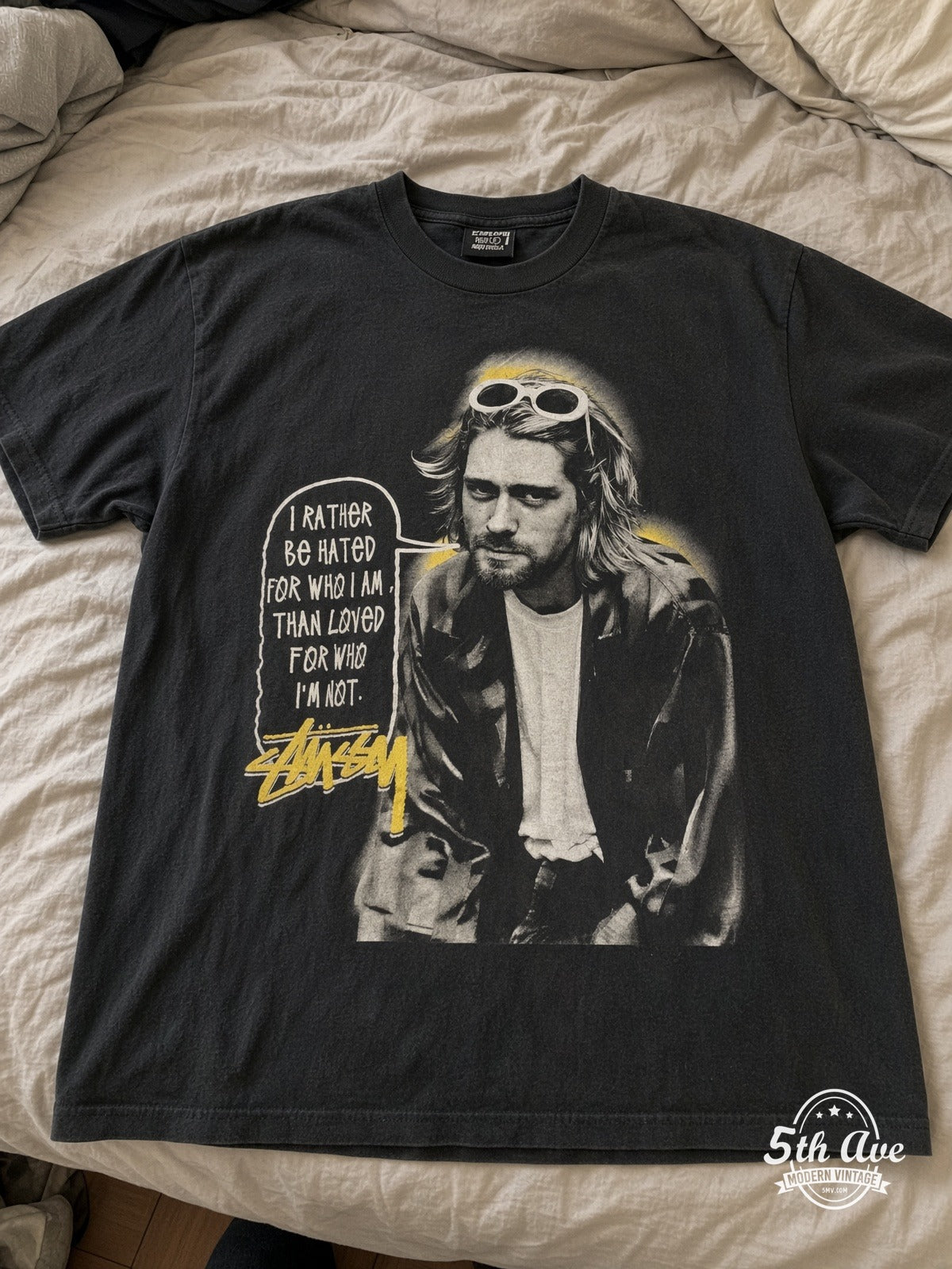 Kurt Cobain Stüssy Halo Quote vintage tee laid on bed