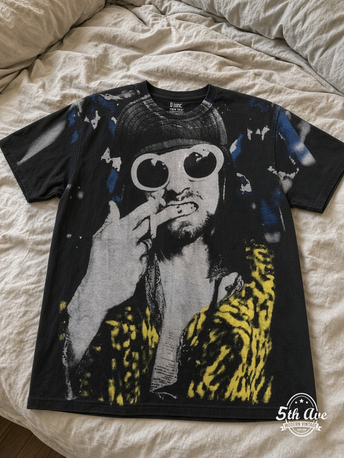 Kurt Cobain Sunglasses Leopard all over print vintage tee laid on bed