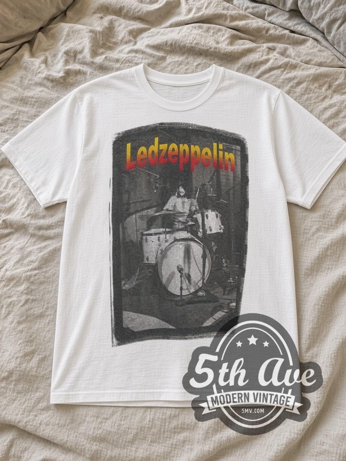 White Led Zeppelin Drummer Tribute Vintage Band T-Shirt laid flat on a linen bed