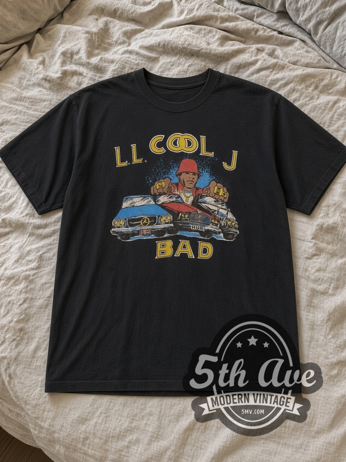 Black LL Cool J Vintage Rap Tee laid flat on a linen bed