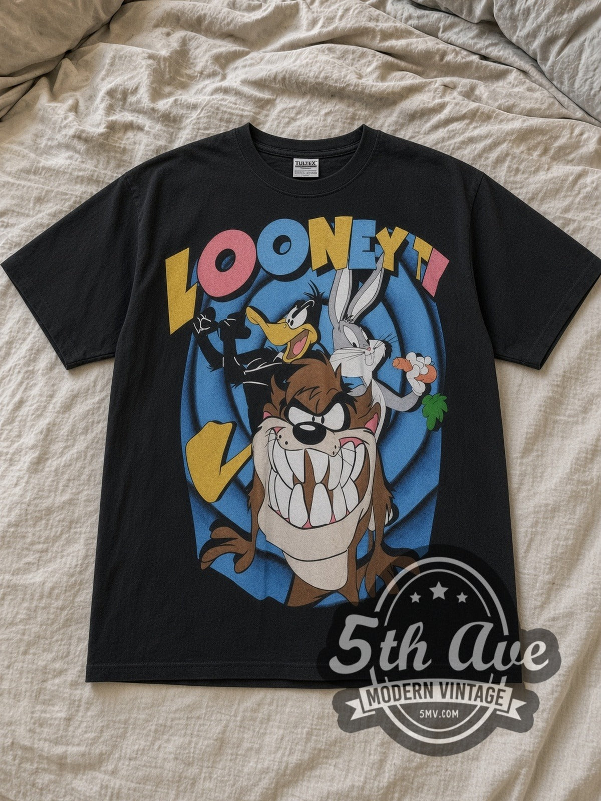Black Bugs Bunny Looney Tunes Bugs Bunny Daffy Duck and Taz Mania Vintage Cartoon T-Shirt laid flat on a linen bed