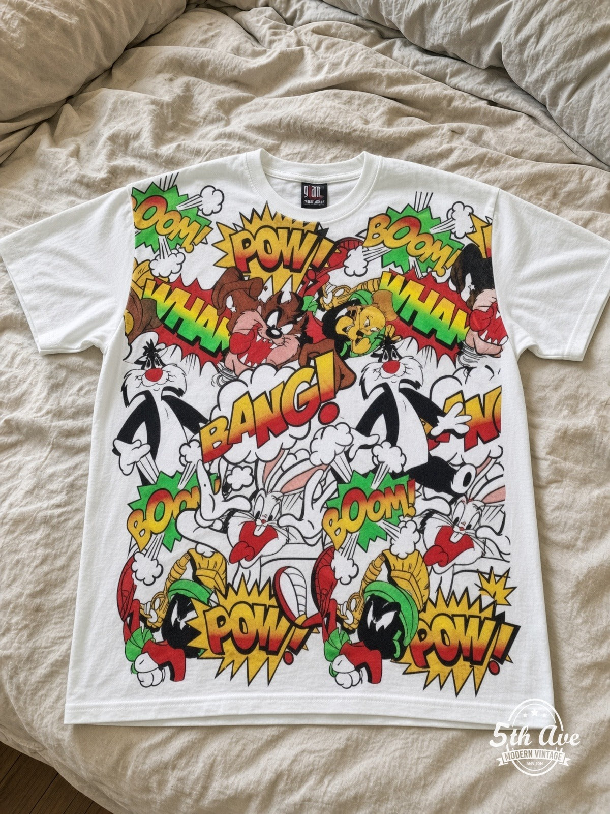 Looney Tunes Comic POW BANG Action Collage vintage tee laid on bed