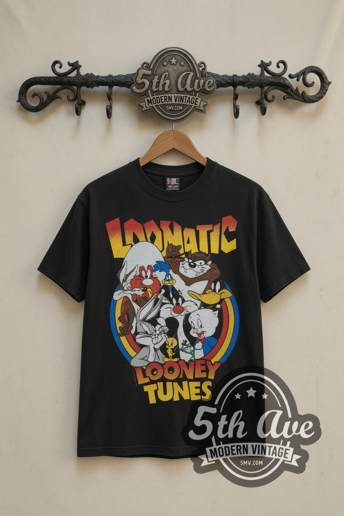 Looney Tunes Loonatic Circle Crest cartoon tee in black, front view on a display rack