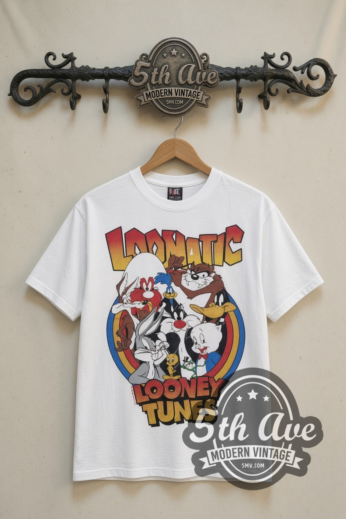 Looney Tunes Loonatic Circle Crest cartoon tee in white, front view on a display rack