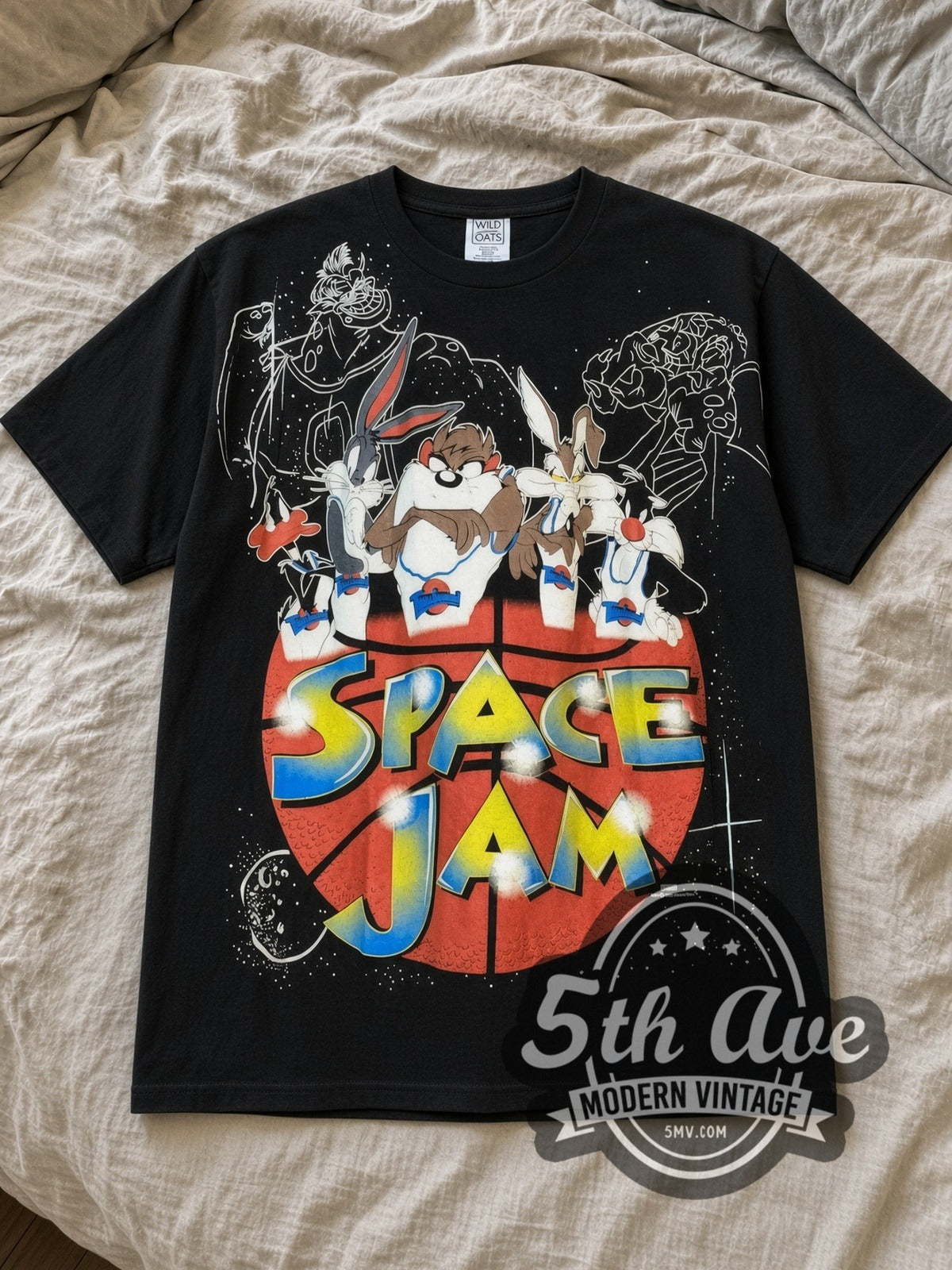 Black Looney Tunes Space Jam Basketball Logo Vintage Cartoon T-Shirt laid flat on a linen bed