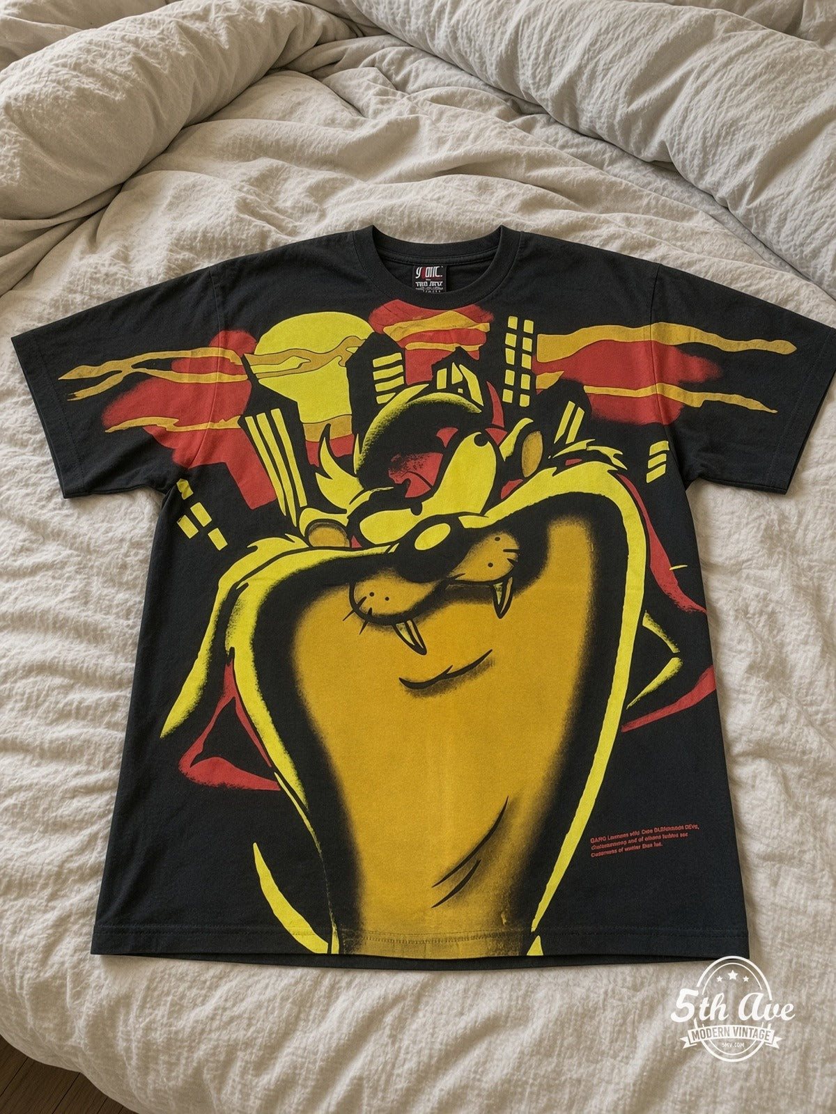 Looney Tunes Sylvester Giant Face Yellow vintage tee laid on bed