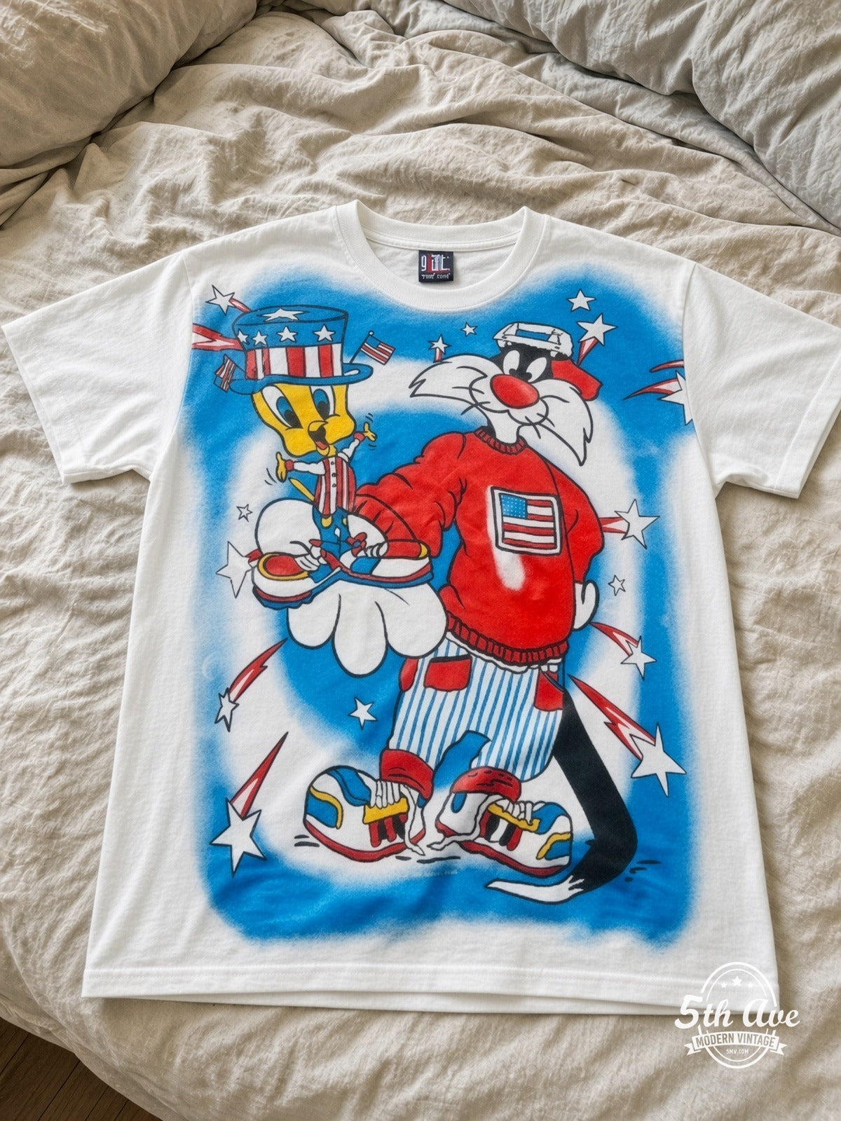 Looney Tunes Sylvester Uncle Sam Patriotic vintage tee laid on bed