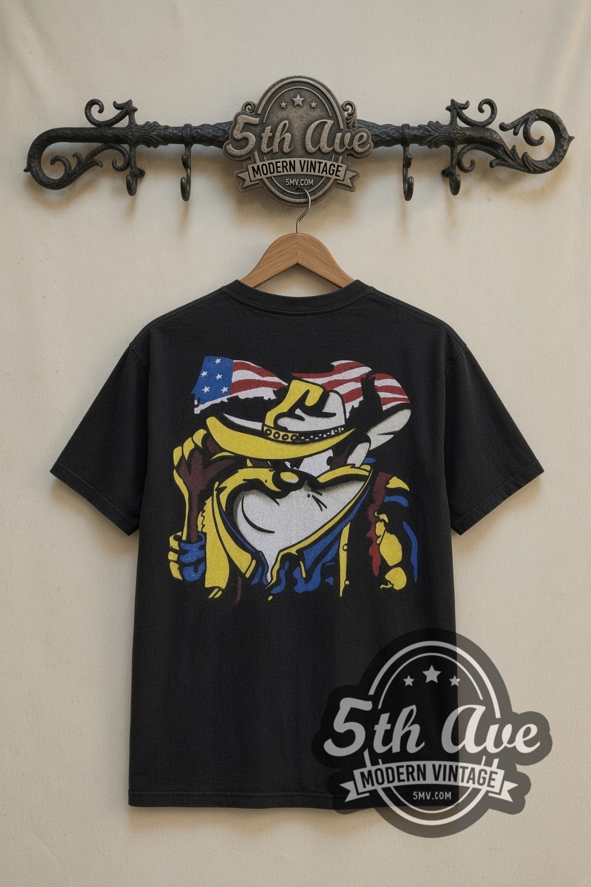Looney Tunes Taz Made in the USA Cowboy Flag cartoon tee in black, back view on a display rack