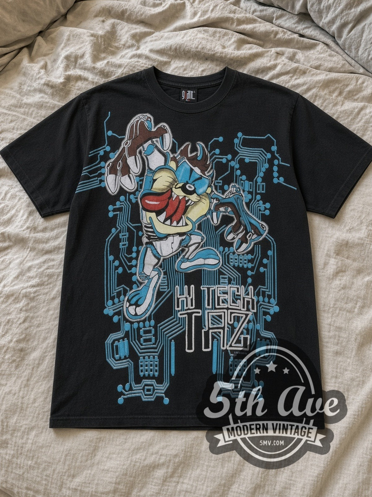 Black Looney Tunes Taz Mania Hi Tech Taz All Over Print Vintage Cartoon T-Shirt laid flat on a linen bed