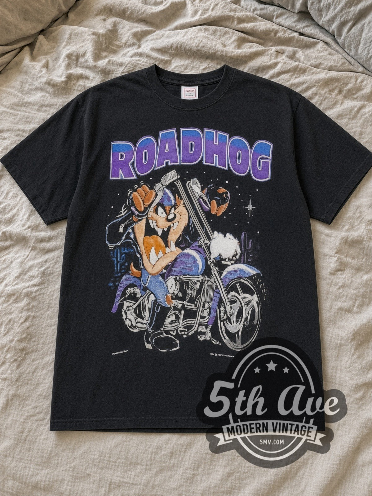 Black Looney Tunes / Harley Davidson Roadhog Vintage Harley-Davidson T-Shirt laid flat on a linen bed