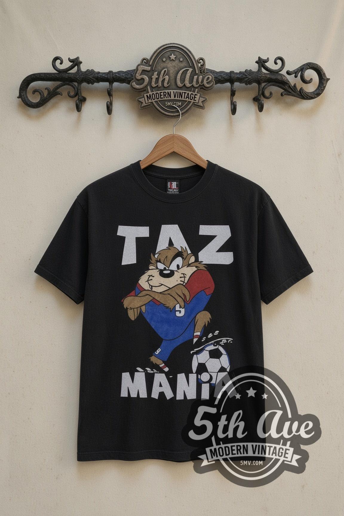 Looney Tunes Taz Soccer Champions cartoon tee in black, front view on a display rack