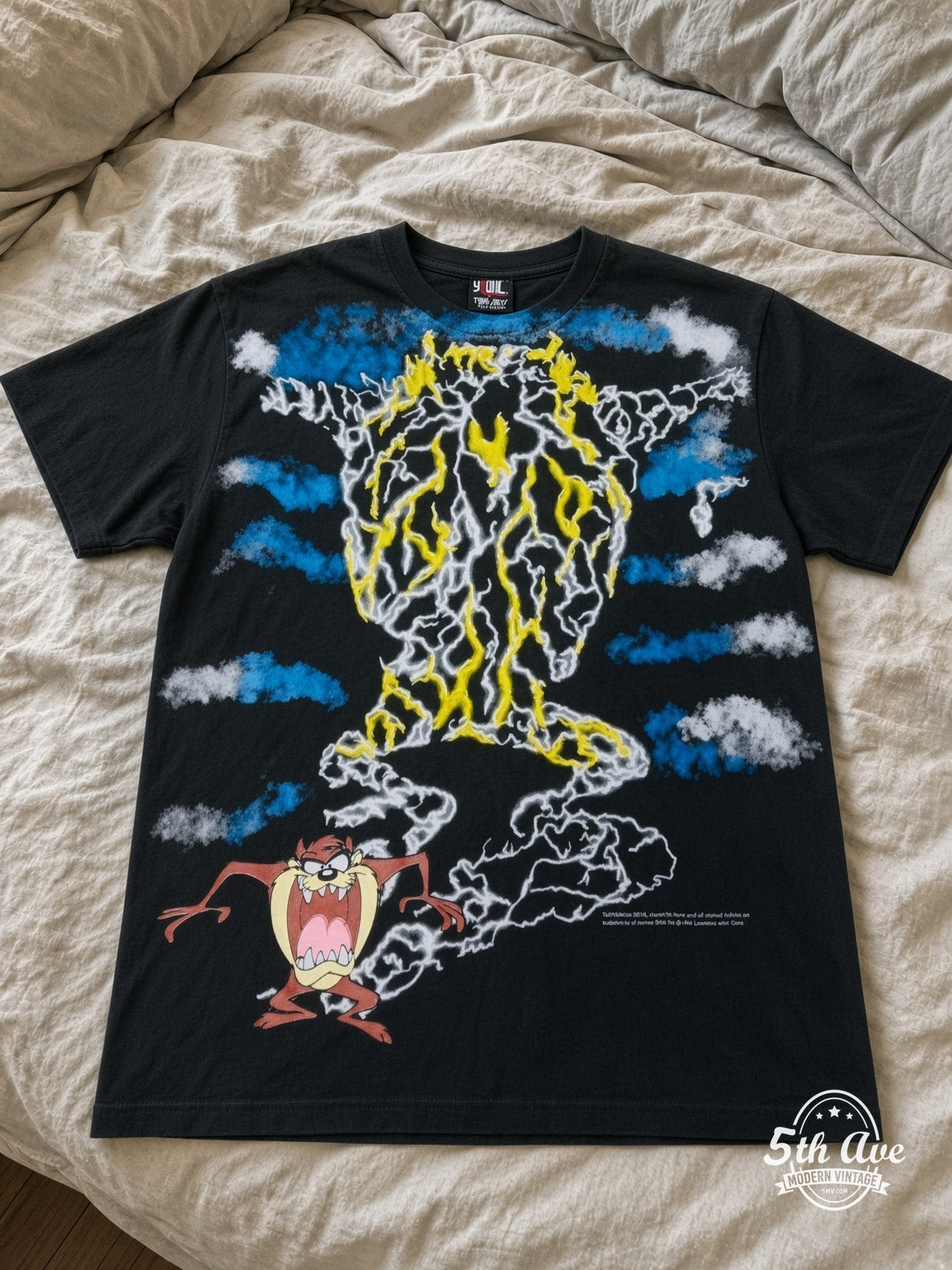 Looney Tunes Taz Tornado Lightning vintage tee laid on bed