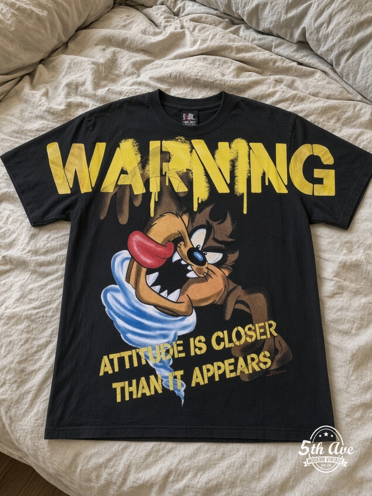 Looney Tunes Taz Warning Attitude vintage tee laid on bed