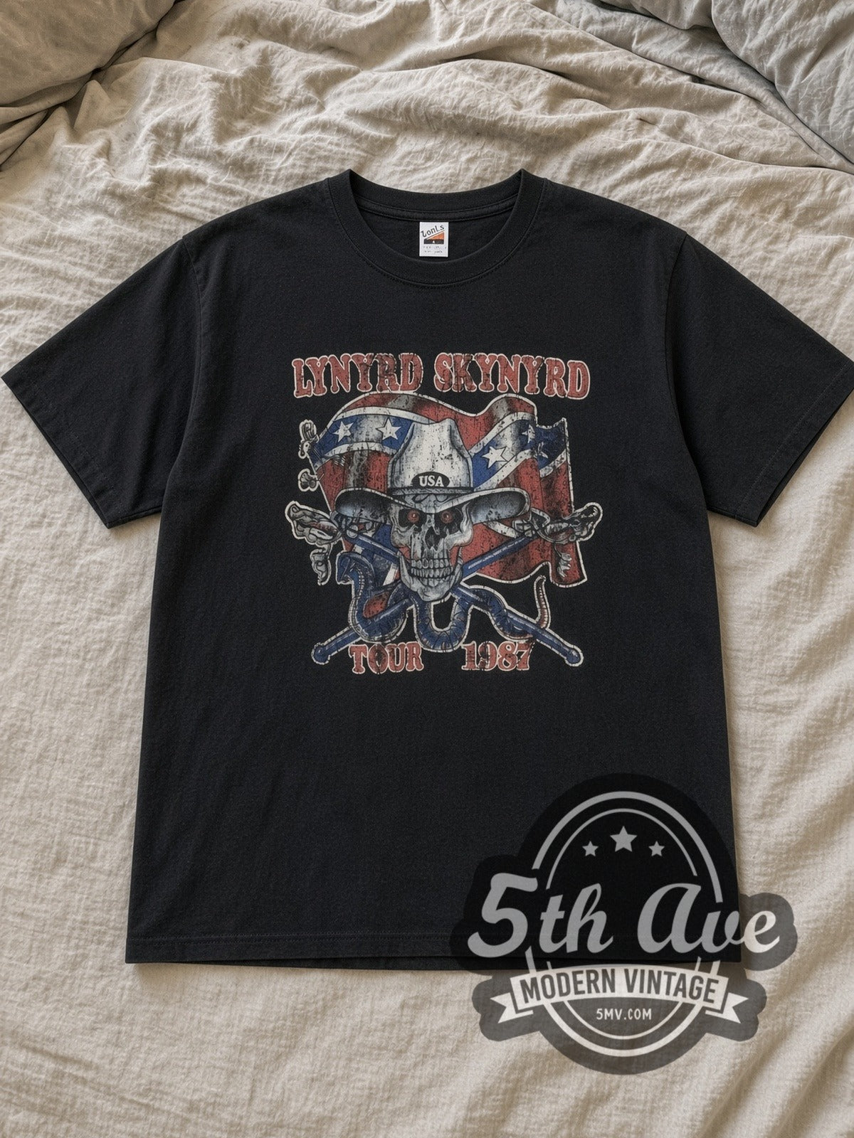 Black Lynyrd Skynyrd 1987 Tour Rebel Skull Vintage Band T-Shirt laid flat on a linen bed