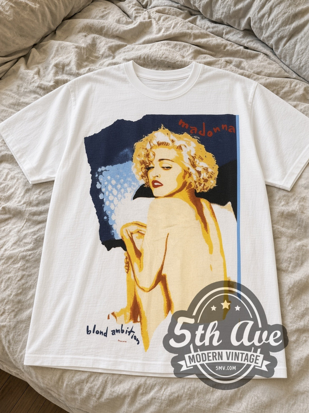 White Madonna Blond Ambition tour tee laid flat on linen bed
