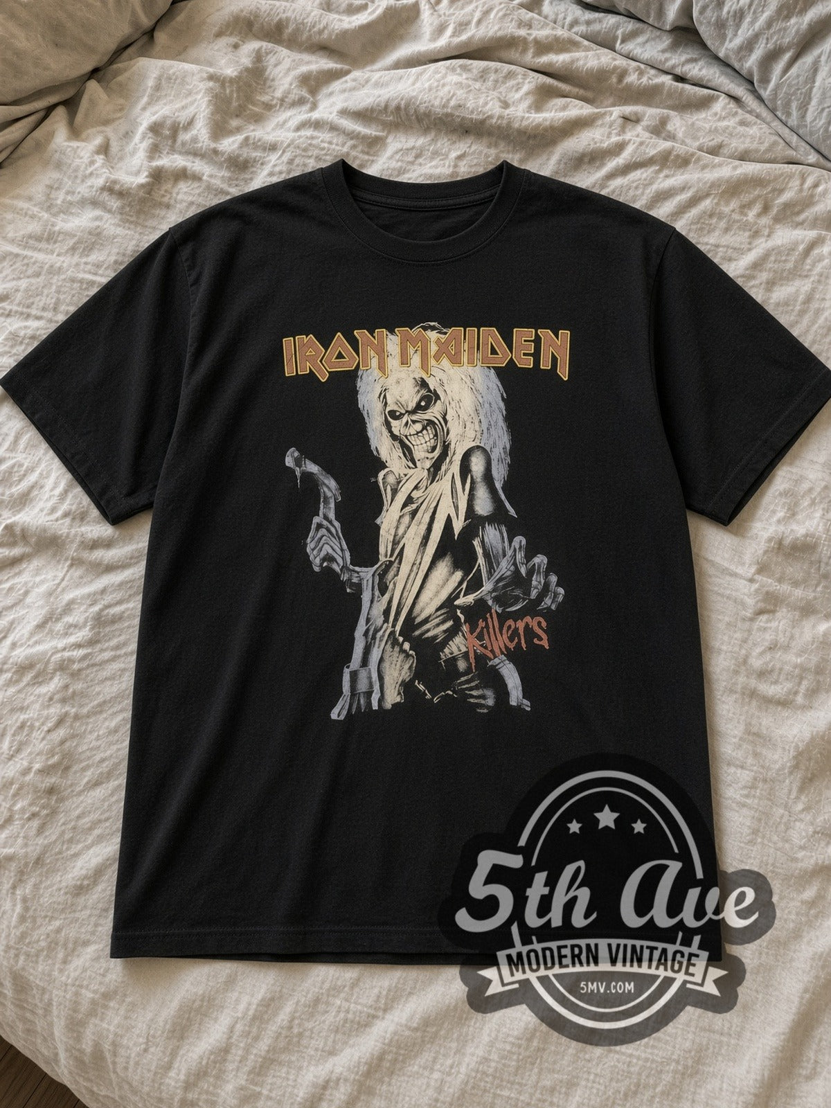 Black Iron Maiden Killers Eddie Hatchet Crop Vintage Band T-Shirt laid flat on a linen bed