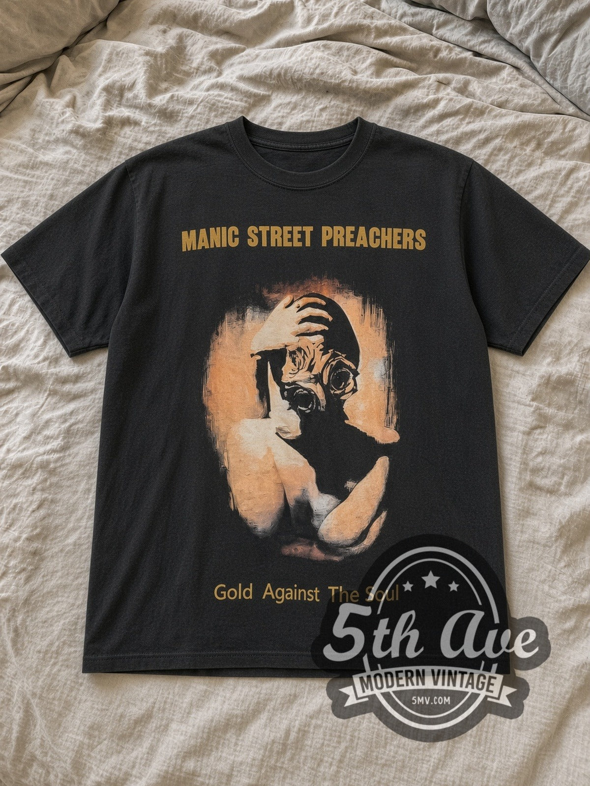 Black Manic Street Preachers Gold Against the Soul Vintage Band T-Shirt laid flat on a linen bed