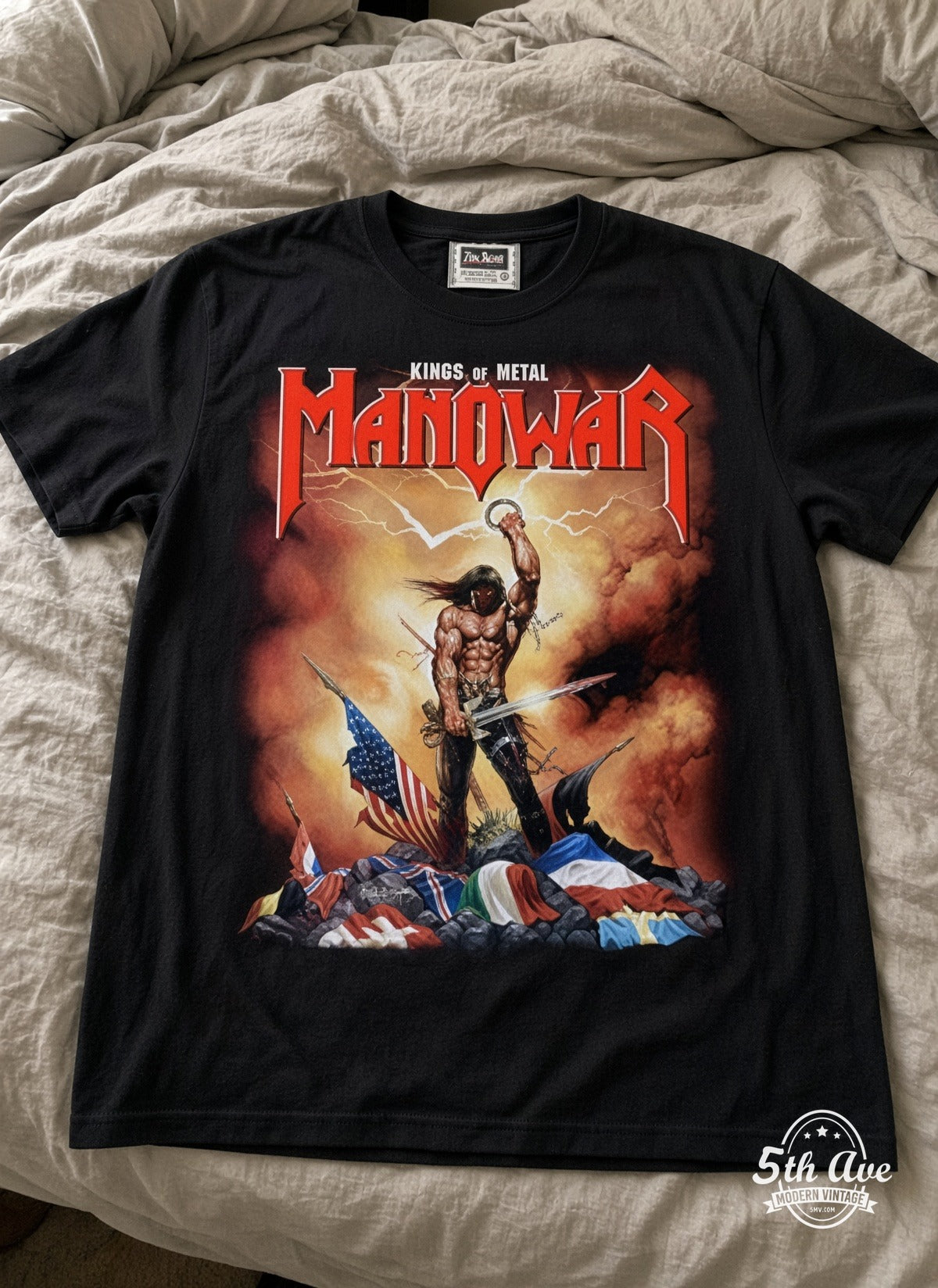 Manowar Kings of Metal vintage t-shirt laid on bed
