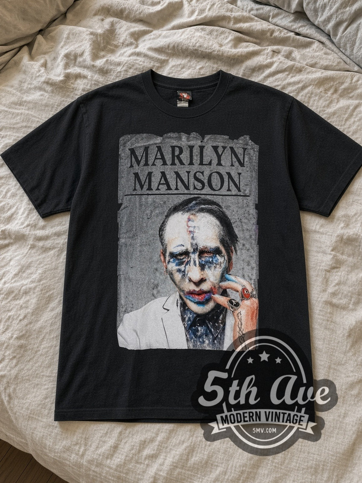 Black Marilyn Manson Clown Makeup Portrait Vintage Band T-Shirt laid flat on a linen bed