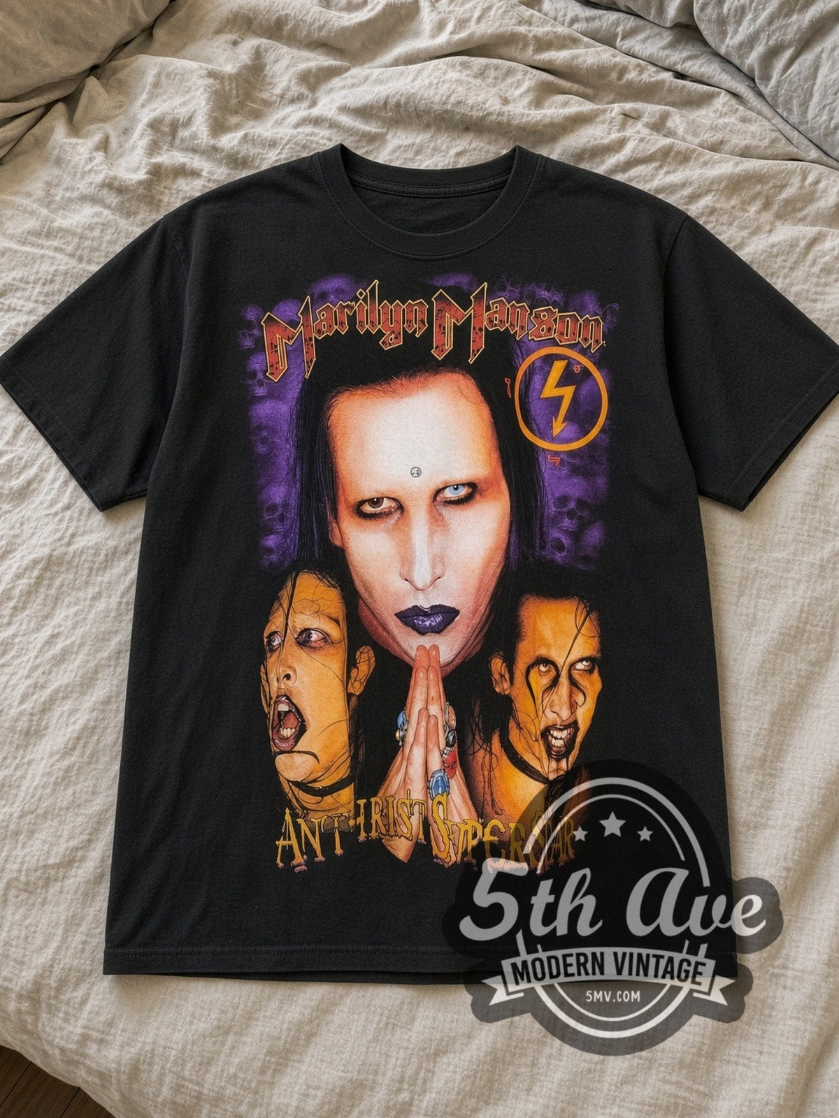 Black Marilyn Manson Antichrist Superstar Prayer Hands Skulls Vintage Band T-Shirt laid flat on a linen bed