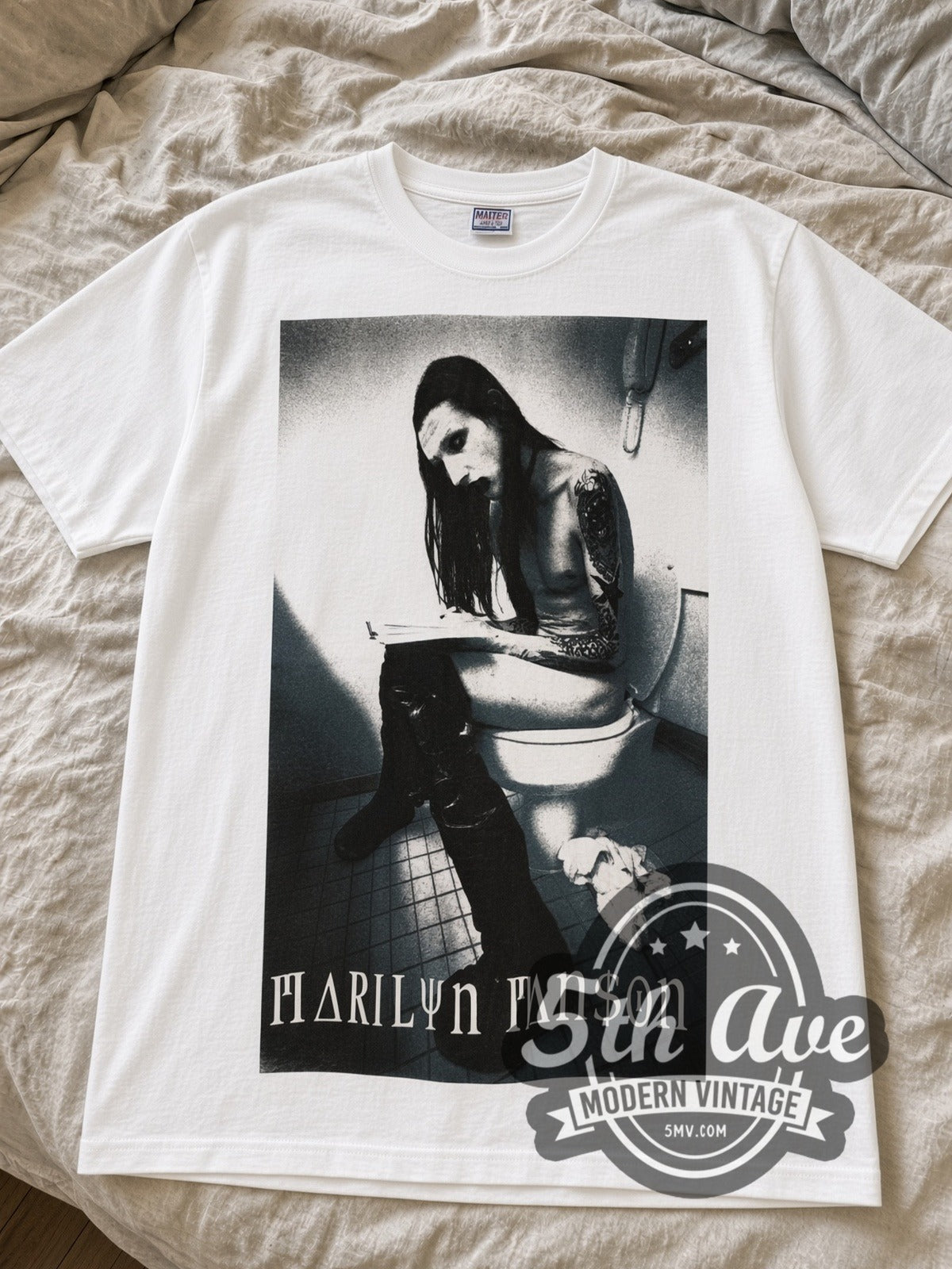 White Marilyn Manson Bathroom Photo & Green Logo vintage band tee laid flat on linen bed