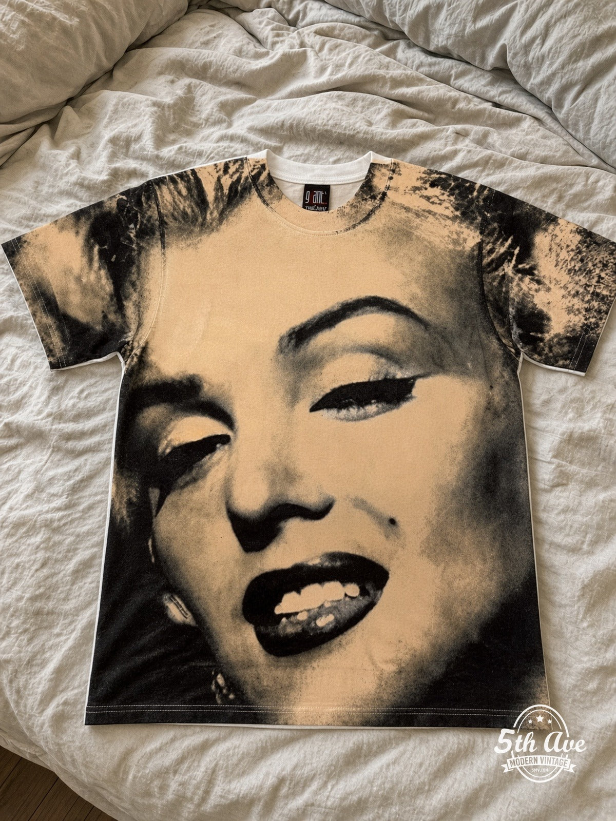 Marilyn Monroe Face Closeup Cream all over print vintage tee laid on bed