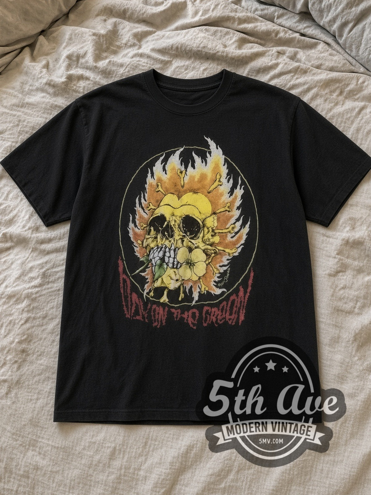 Black Metallica and Friends 1991 Vintage Band T-Shirt laid flat on a linen bed