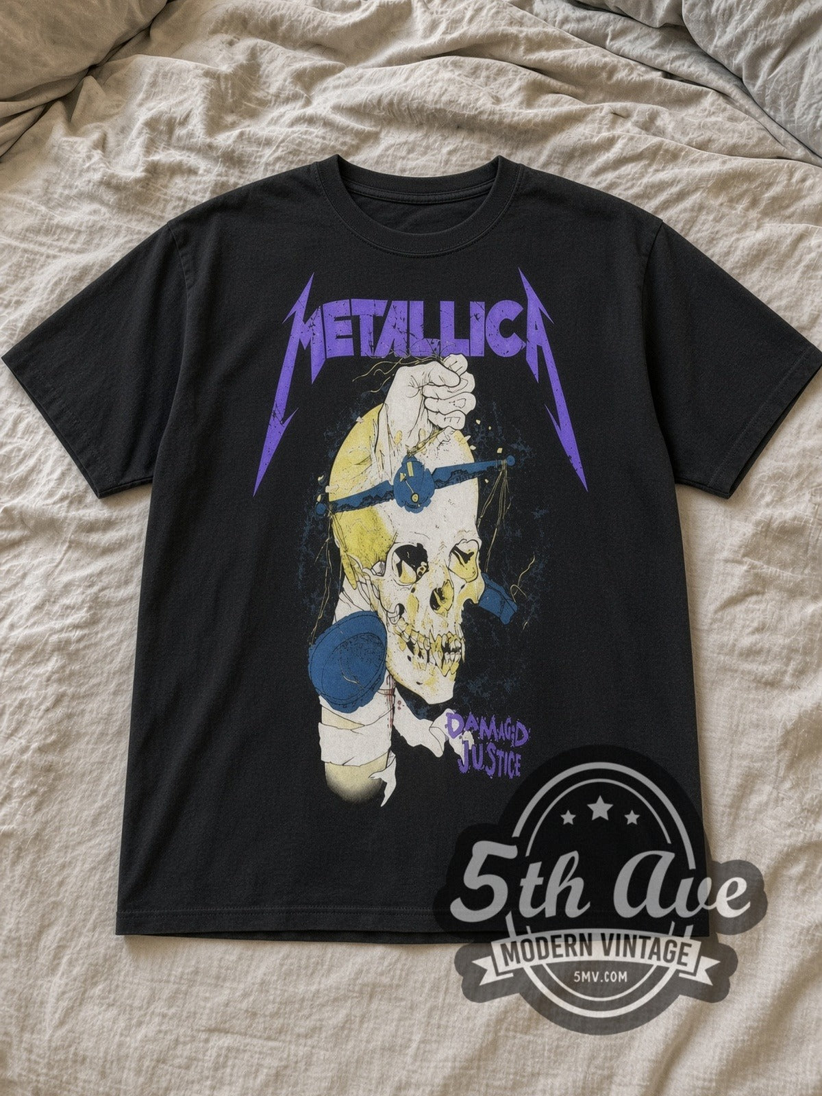 Black Metallica Damaged Justice Fist Through Skull Vintage Band T-Shirt laid flat on a linen bed