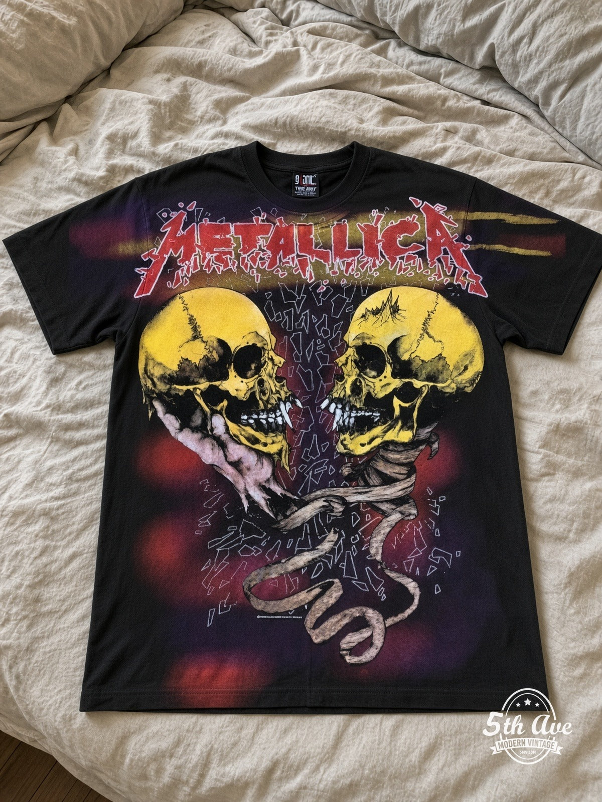 Metallica Dual Skulls Snake all over print vintage tee laid on bed